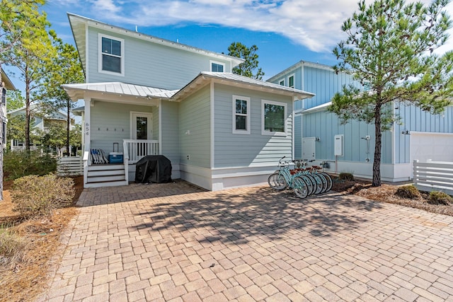654 Flatwoods Forest Loop, Santa Rosa Beach, FL 32459 - rear view of house featuring a metal roof
