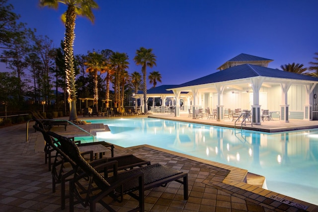 654 Flatwoods Forest Loop, Santa Rosa Beach, FL 32459 - pool at twilight with a community pool and a patio area