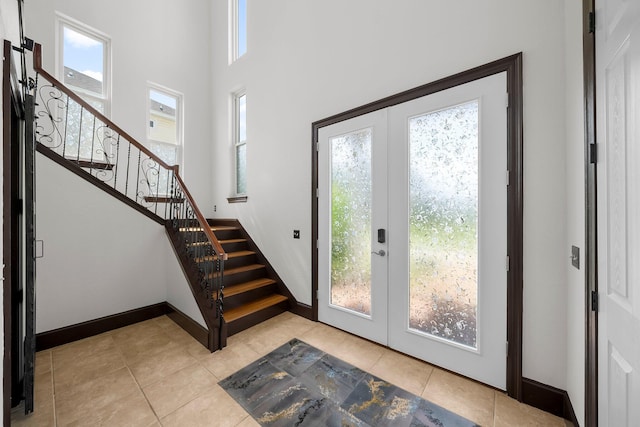 3929 Indian Springs Rd, Panama City, FL 32404 - entryway with french doors, stairway, light tile patterned flooring, and a towering ceiling