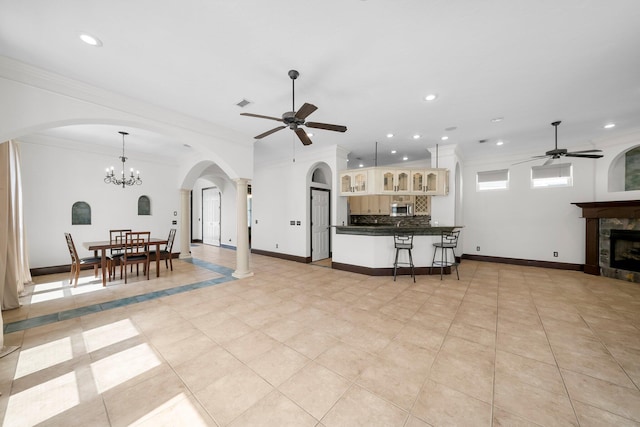 3929 Indian Springs Rd, Panama City, FL 32404 - living area featuring ceiling fan, arched walkways, ornamental molding, recessed lighting, and a tile fireplace