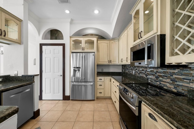 3929 Indian Springs Rd, Panama City, FL 32404 - kitchen with stainless steel appliances, crown molding, cream cabinets, backsplash, and light tile patterned floors