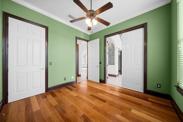 3929 Indian Springs Rd, Panama City, FL 32404 - unfurnished bedroom featuring light wood-style flooring, crown molding, ensuite bath, and ceiling fan