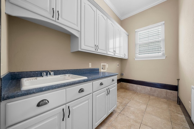 3929 Indian Springs Rd, Panama City, FL 32404 - washroom featuring hookup for a washing machine, ornamental molding, cabinet space, light tile patterned floors, and hookup for an electric dryer