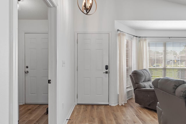 277 Limestone Cir, Crestview, FL 32539 - entryway with wood finished floors, a chandelier, arched walkways, and a textured ceiling