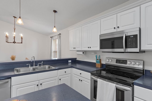 277 Limestone Cir, Crestview, FL 32539 - kitchen with stainless steel appliances, dark countertops, a chandelier, white cabinets, and vaulted ceiling