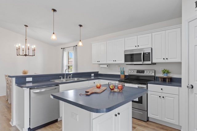 277 Limestone Cir, Crestview, FL 32539 - kitchen featuring dark countertops, stainless steel appliances, a peninsula, light wood-style floors, and white cabinets