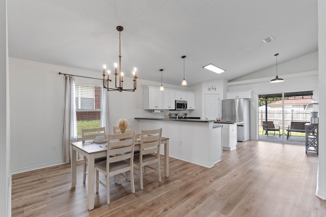 277 Limestone Cir, Crestview, FL 32539 - dining area featuring vaulted ceiling, a chandelier, and light wood finished floors