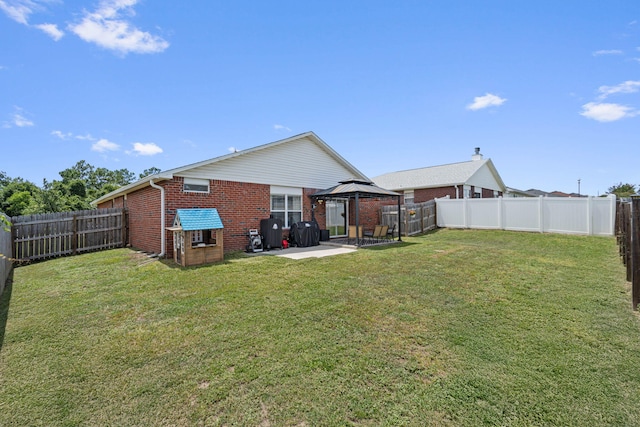 277 Limestone Cir, Crestview, FL 32539 - rear view of house with a gazebo, brick siding, a patio area, and a fenced backyard