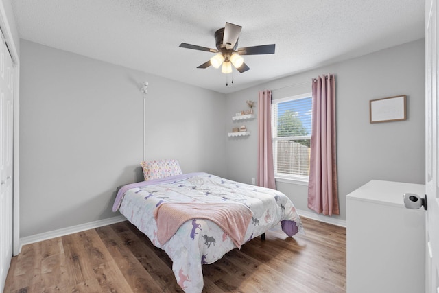 277 Limestone Cir, Crestview, FL 32539 - bedroom with light wood finished floors, a textured ceiling, and a ceiling fan