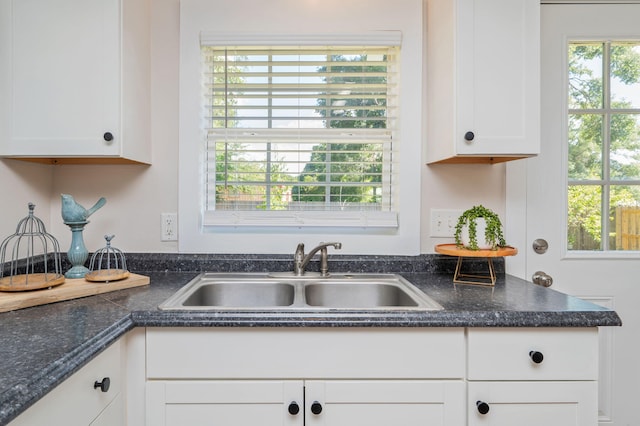 379 W 1st Ave, Crestview, FL 32536 - kitchen with white cabinetry and dark countertops