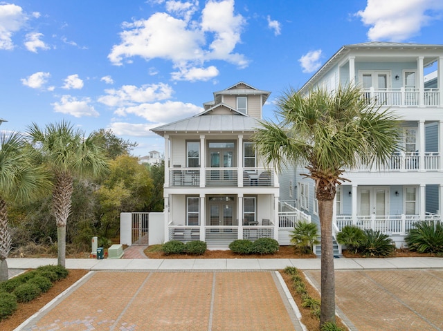 18 E Trigger Trl, Inlet Beach, FL 32461 - view of front of home with french doors, a balcony, a gate, and stucco siding