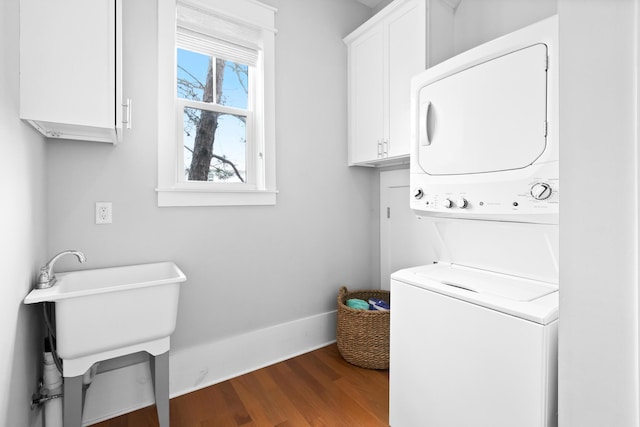 12 Seabreeze Way, Inlet Beach, FL 32461 - laundry area featuring stacked washer / drying machine, cabinet space, and dark wood finished floors