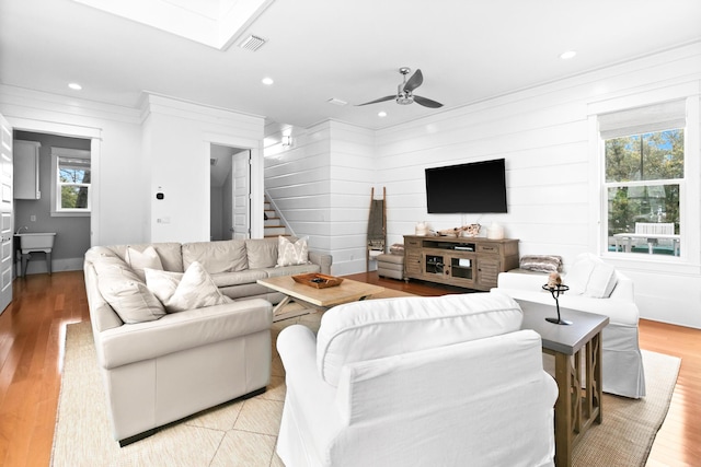 12 Seabreeze Way, Inlet Beach, FL 32461 - living area with ornamental molding, stairs, plenty of natural light, ceiling fan, and light wood-style flooring