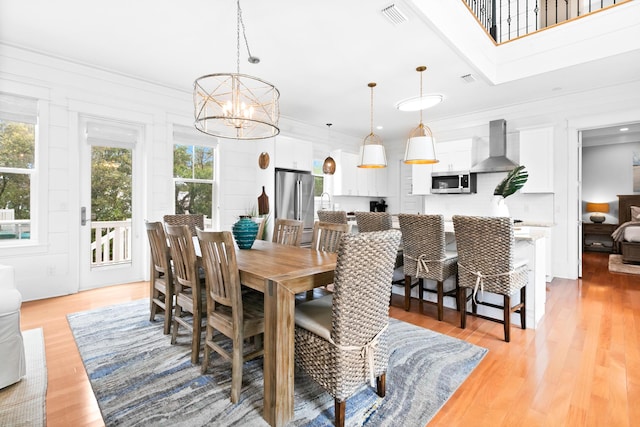 12 Seabreeze Way, Inlet Beach, FL 32461 - dining room with a chandelier, plenty of natural light, light wood finished floors, and ornamental molding