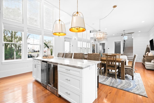 12 Seabreeze Way, Inlet Beach, FL 32461 - kitchen featuring open floor plan, white cabinets, pendant lighting, a kitchen island, and beverage cooler