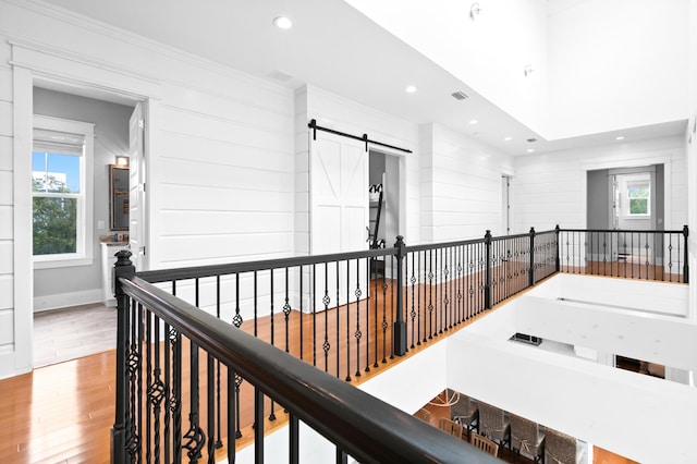 12 Seabreeze Way, Inlet Beach, FL 32461 - corridor featuring wood finished floors, an upstairs landing, a barn door, recessed lighting, and crown molding