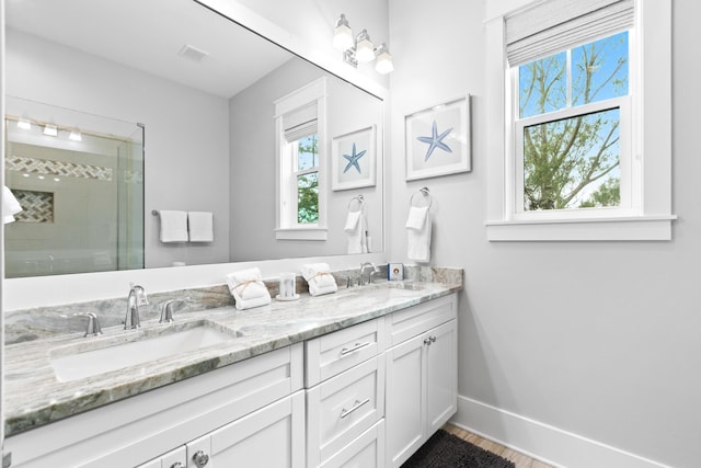 12 Seabreeze Way, Inlet Beach, FL 32461 - full bathroom featuring double vanity, plenty of natural light, a stall shower, and wood finished floors