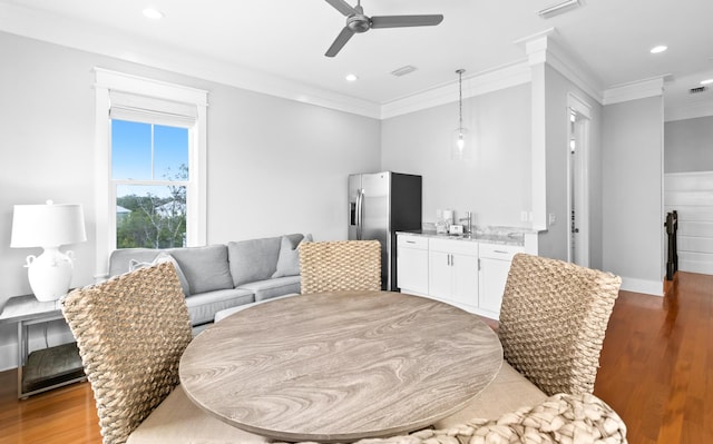 12 Seabreeze Way, Inlet Beach, FL 32461 - dining area featuring light wood-type flooring, ornamental molding, bar with sink, ceiling fan, and recessed lighting