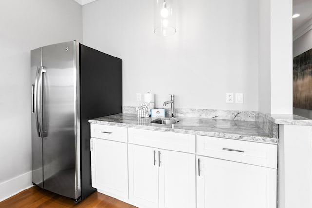 12 Seabreeze Way, Inlet Beach, FL 32461 - kitchen with stainless steel fridge with ice dispenser, light stone countertops, dark wood-type flooring, and white cabinetry