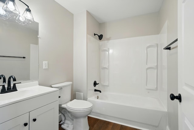 bathroom featuring toilet, shower / tub combination, wood finished floors, and vanity