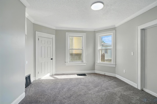 unfurnished room featuring carpet flooring, a textured ceiling, and visible vents