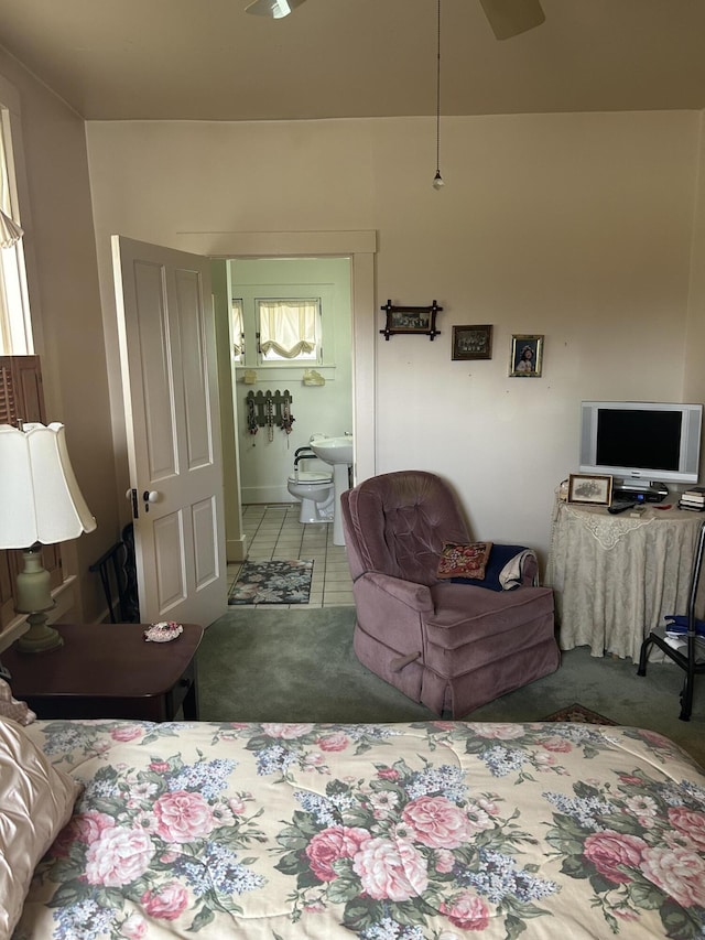 bedroom with ensuite bath and carpet floors