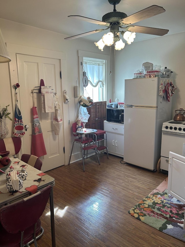 interior space with ceiling fan, hardwood / wood-style floors, and white appliances