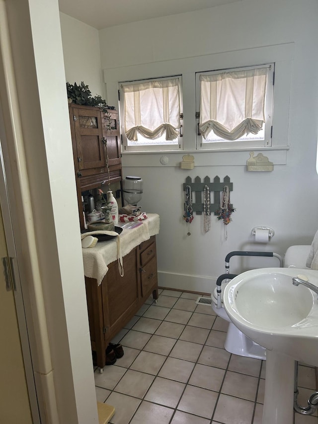 bathroom featuring tile patterned flooring and toilet