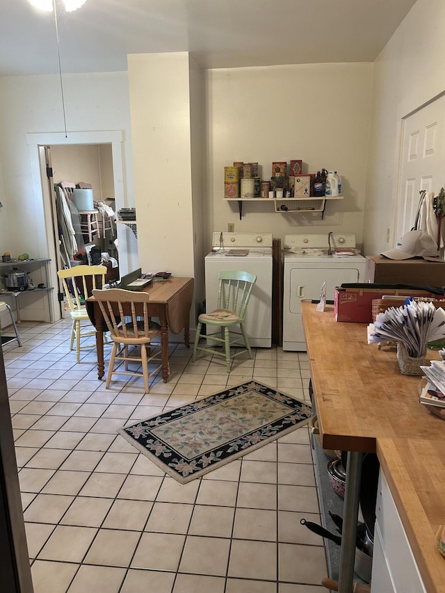 interior space featuring separate washer and dryer and light tile patterned floors