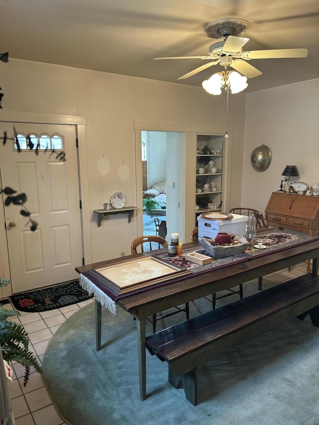 tiled dining room featuring ceiling fan