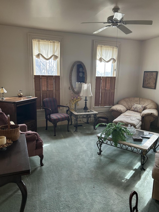 living room featuring ceiling fan, carpet floors, and a wealth of natural light