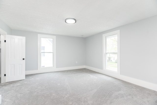 unfurnished room featuring baseboards and carpet floors