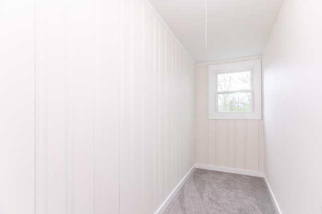carpeted empty room with baseboards
