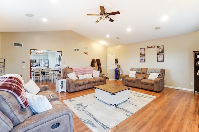 living room featuring light wood-type flooring, lofted ceiling, and ceiling fan