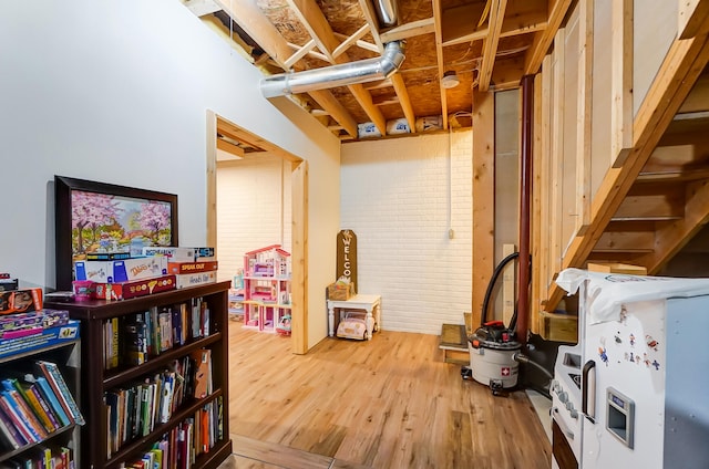 basement with hardwood / wood-style flooring