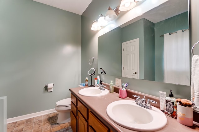 bathroom featuring toilet and vanity