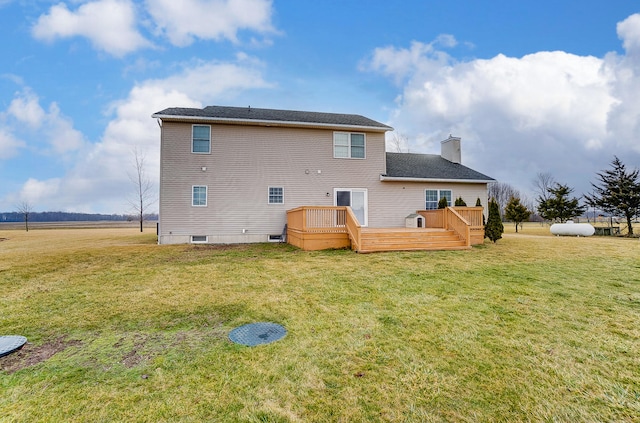 rear view of property with a yard and a deck