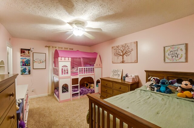 bedroom featuring a textured ceiling, ceiling fan, and light colored carpet