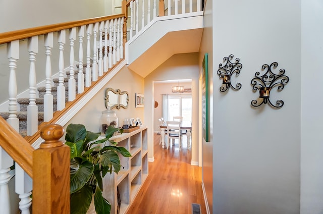 corridor featuring a high ceiling and hardwood / wood-style floors