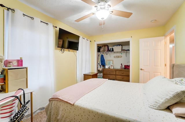 bedroom with ceiling fan and a closet