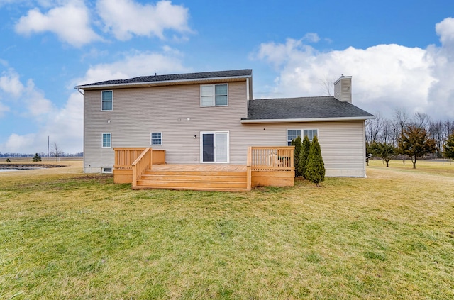 back of property featuring a wooden deck and a lawn