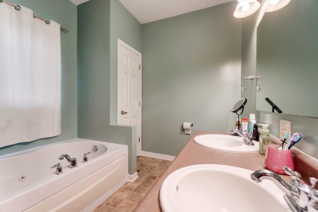 bathroom with vanity and a bath