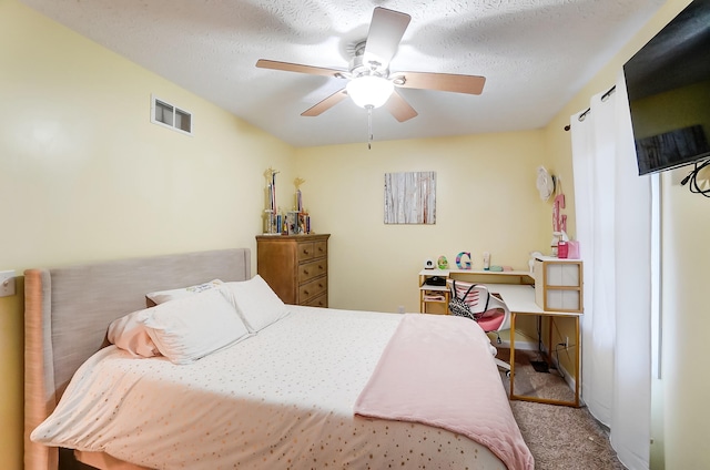 carpeted bedroom with a textured ceiling and ceiling fan