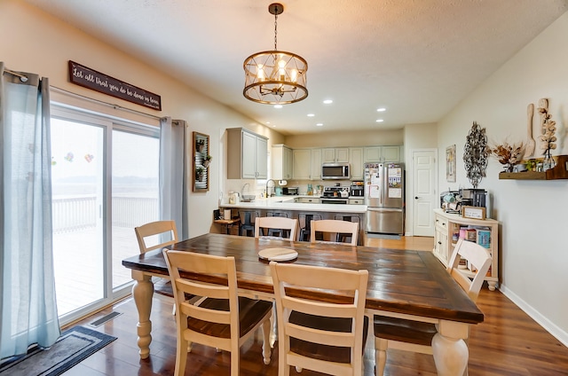 dining space featuring a chandelier and wood-type flooring