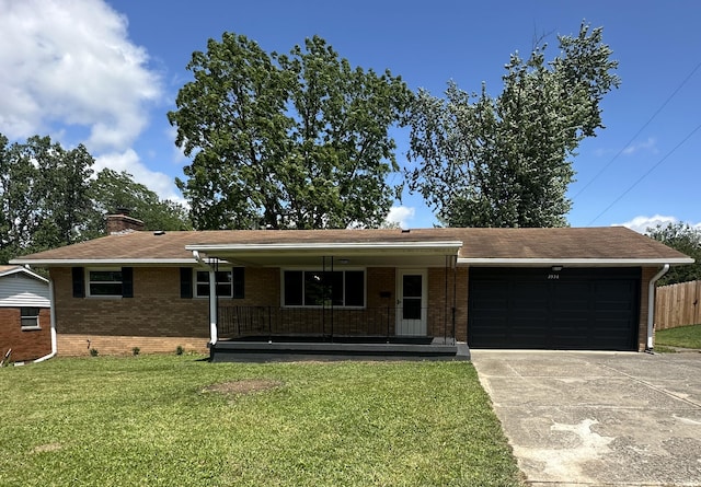 2336 Derr Rd, Springfield, OH 45503 - ranch-style house with a garage, brick siding, driveway, a chimney, and a porch