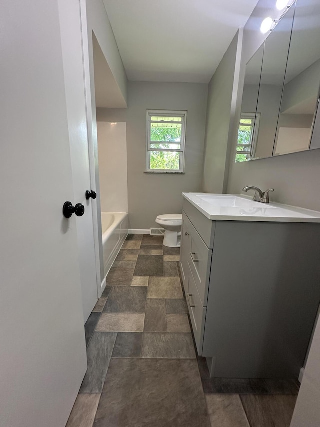 2336 Derr Rd, Springfield, OH 45503 - bathroom featuring vanity, healthy amount of natural light, a tub, and stone finish floors