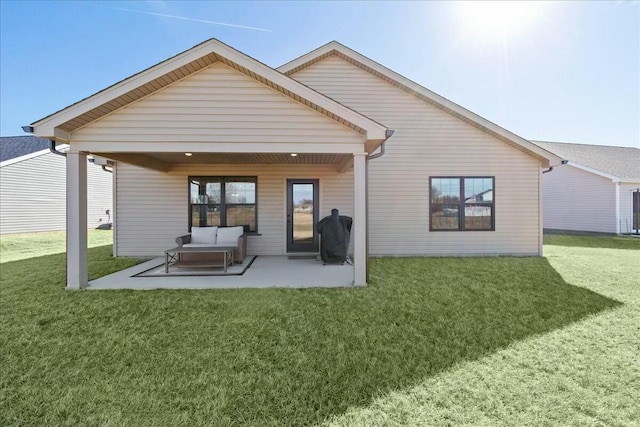 rear view of property featuring a yard and a patio area