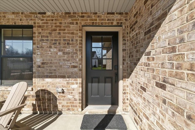 property entrance with brick siding