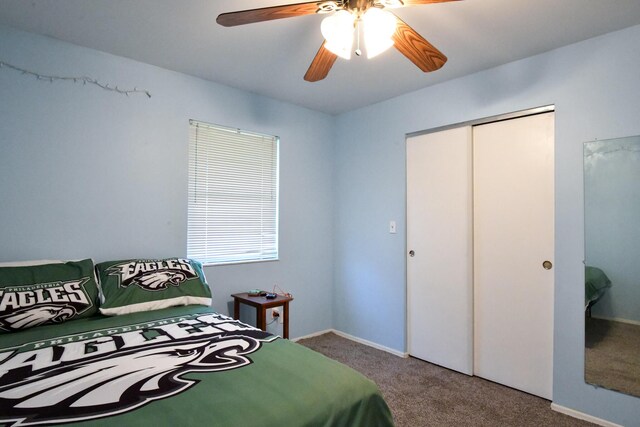 bedroom with ceiling fan, carpet, and a closet