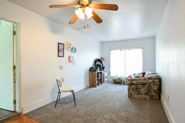 living area with carpet floors, a ceiling fan, and baseboards